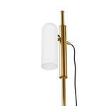Angled close-up of glass diffuser and short horizontal brass arm holding fabric-covered power cord