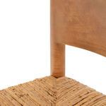 Detailed view of curved wooden backrest corner and top of supporting leg