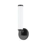 Old bronze wall sconce with round backplate, thick rectangular arm, and cylindrical opal glass shade with knurled metal ends