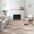 Rug in a styled living room setting with fireplace, sofa, and armchair emphasizing room integration