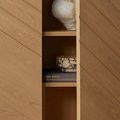 Close-up of bowl on a shelf behind partially open wooden cabinet door