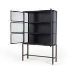 Spencer Curio Cabinet styled with ceramics and books in a neutral living space with green wall and wood floor