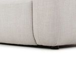 Close-up of bottom corner junction between seat cushion and armrest with visible seam detail