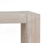 Extreme close-up of joinery with visible wood grain patterns and light finish on block leg