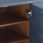 Interior close-up showing wood shelf and hinge mechanism inside blue cabinet