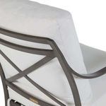 Close-up view of chair’s back cushion and X-frame showing sleek metal finish and cushion seams