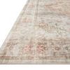 Close-up angled view showing the rug’s low pile texture and faded vintage floral medallion details