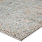 Close-up angled view of rug corner showing detailed weave and delicate border pattern