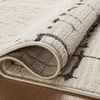 Rolled edge close-up showing backside weave and plush front texture of Darby Sand / Dk. Grey rug