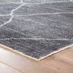 Rectangular gray Satellite Rug with a geometric white line pattern on a wooden floor, soft polypropylene texture