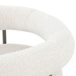 Detailed close-up of boucle fabric texture on the curved backrest