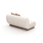 Rear angled view displaying the oatmeal fabric backrest and camel faux mohair base without seams or additional details