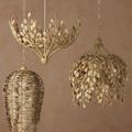 Maypan Pendant hanging on the right side with two other distinct pendant styles against a muted wall