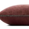 Side profile of wine velvet pillow showing thickness and detailed piped edging