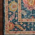 Detailed close-up of the rug corner on a wooden floor highlighting hooked wool texture and color variations