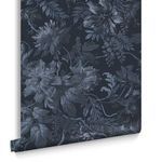 Rolled wallpaper showing texture and fold detail with visible floral pattern in dark blues