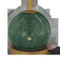 Another close-up of green marble base showing subtle white veining and brass detail