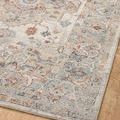 Angled view of rug corner with clear view of medallion and muted colors on wooden floor