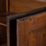 Close-up of two sideboard doors slightly open showing interior wood and shelves