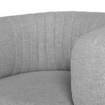 Close-up of Reina Accent Chair's textured gray upholstery and vertical channel stitching on back and arm