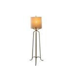 Floor lamp switched on showing warm light through fabric shade on plain background