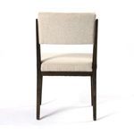 Close-up showing sharp corner of cushioned seat meeting wood frame