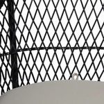 Close-up detail of woven diamond pattern on chair backrest around hanging fabric loop