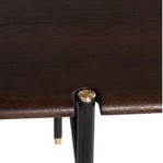 Close-up of table corner showing smoked wood finish, metal leg insertion, and gold accent cap