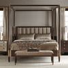 Centered Clarendon canopy bed with bench, paired nightstands, and symmetrical lamps in neutral room