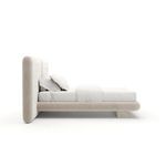 Side profile view highlighting low platform bed frame and thick cushioned headboard depth