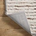 Rug corner flipped to show gray woven backing texture