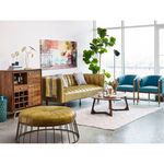 Wide room context showing Godenza table as centerpiece with green and teal mid-century seating and large indoor plant