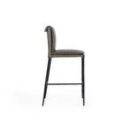 Side profile of Mayer Stool highlighting slim legs and rolled top of leather backrest