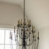 Erika Three-Tier Chandelier suspended in room with vaulted ceiling and large window in background