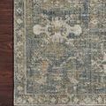 Close-up of rug on wood floor highlighting muted geometric and floral pattern and edge binding
