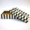 Similar open box angle with slight variation in lid position, revealing interior depth and striped exterior