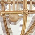 Close-up of natural rattan knots and wooden ball detail at the base of the chandelier