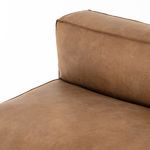Close-up on junction of seat and back cushions showing soft leather and smooth piping