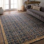 Rug styled in living room with gray sofa, wood table, beige pillows, and natural light
