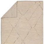 Tepal rug corner folded to reveal the woven natural wool backing in cream and brown tones