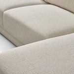 Close-up showing stitching and seam detail between seat cushions and armrest fabric