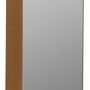 Side angle showing gold metal cabinet depth and smooth rounded edges