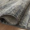 Close-up of the rug’s pile texture rolled over on a wood floor