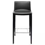 Modern black Palma Bar Stool with padded seat and backrest, slim legs, and chrome footrest