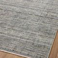 Tilted close-up showing Soho Jade / Stone rug’s pattern and colors at one corner with visible edge stitching