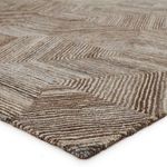 Close-up of rug corner showing thick, textured micro-tufted wool and viscose fibers in neutral shades
