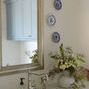 Wide angle of kitchen sink area showing styled cream vase with flowers and silver fixtures