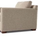 Back side angle emphasizing structured form and wide armrest of upholstered chair