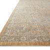 Close-up low angle of rug's textured edge showing gold border and fringe detail
