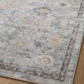 Close-up of Monroe rug’s varied motifs and subtle gold accents on wooden floor
